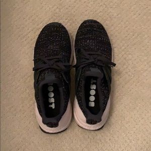 Black and pink Adidas ultra boost running shoes.